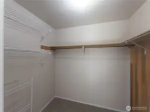 Large walk in closet with shelving.
