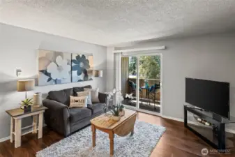 Living room with sliders out to the outdoor deck.