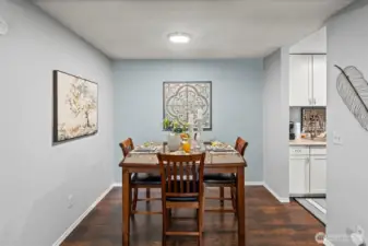 Host a gathering and serve food at the dining room table,  conveniently adjacent to the kitchen.