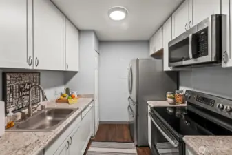 Stainless steel appliances and white cabinets combine for a modern look.