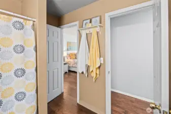 Bathroom is accessed by both hallway and primary bedroom