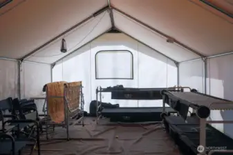 Inside the Basecamp tent, wood tarped floor, and sleeping bunks. Although you can't see it in this photo, there is a wood stove in the corner.