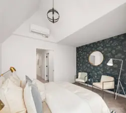 Spacious and dreamy primary suite offers vaulted ceilings, stylish accents, a walk-in closet and luxurious primary bath.