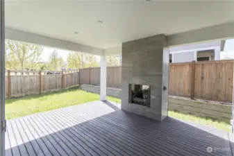 Signature Outdoor Room, pre-wired for ceiling fan, features full-height-tiled gas fireplace