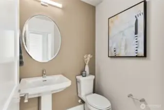 Main floor powder bathroom with pedestal sink.