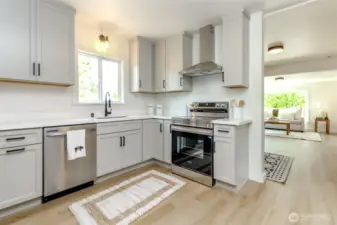 Kitchen w/stainless brand new appliances and quartz countertops.