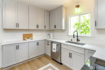 Kitchen w/stainless brand new appliances and quartz countertops.