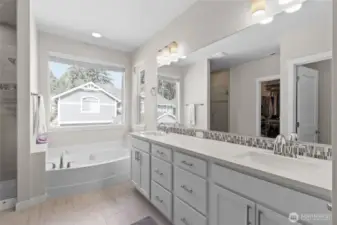 Spacious Primary bath w/dual vanities, separate bath shower and walk-in-closet