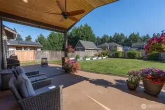 Relax under the covered back patio. The ceiling fan provides a little breeze