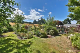 EnJOY gorgeous western territorial views of Fossek Farm's rolling hills and pasture. There is a fenced berry garden (straight ahead and to the right edge of this photo).