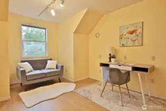 This is a flex space adjacent to the Primary Suite and Bedroom #5. The window looks out to the east side (Gleason Lane) of the home. Floors here are laminate. The rest of the upper level is wall to wall carpet.