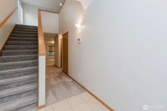 Staircase view from the foyer with natural light.