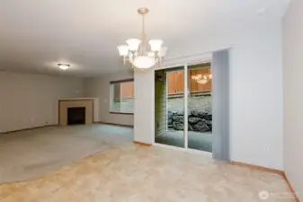 Dining area with chandelier and access to the backyard.