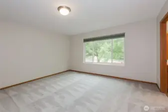 Secondary bedroom with plush carpet.