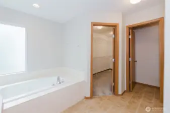Relaxing soaking tub with bright window.