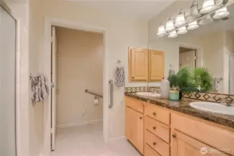 Primary bathroom with double vanity & step-in shower.
