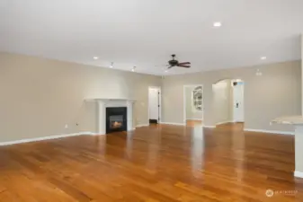 Great room looking back toward entry hall and entry to office/den and Primary Bedroom