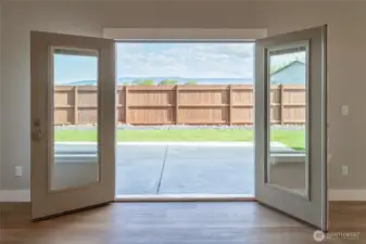 Double doors leading out onto covered rear patio