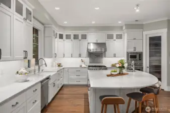 A chef's kiss to this kitchen with marble countertops, Viking Appliances, bosch dishwasher, Sub Zero Fridge, and a walk in pantry.