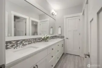 Shared on suite bathroom with Bedroom 3.  With plenty of counter space to spread out and a linen closet.