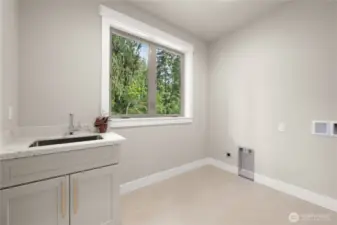 Laundry with byilt in cabinet with sink