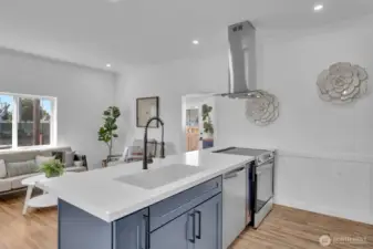 Great view from the kitchen sink of the living room and through the laundry room to the back door