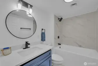 Bathroom off the laundry room with extra deep tub and new tile!