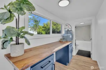 Beautiful custom wood table top in the laundry room with some extra storage!