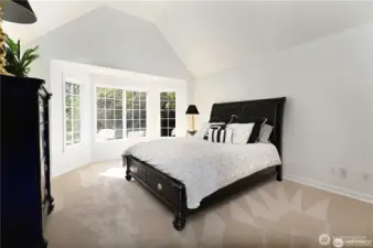 One of four additional bedrooms located on the main level features a charming bay window, adding natural light and architectural interest.