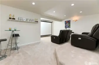 Enjoy an immersive movie experience in the multilevel theatre room, designed with tiered seating for optimal viewing and comfort.