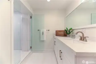 The basement includes a full bathroom featuring a custom tiled built in shower, sleek quartz countertops and new cabinetry.