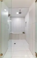 This custom designed spa shower is complete with multiple showerheads, custom lighting and glass door, built in shower bench and tiled floor and walls - offering a relaxing, spa-like experience right at home.