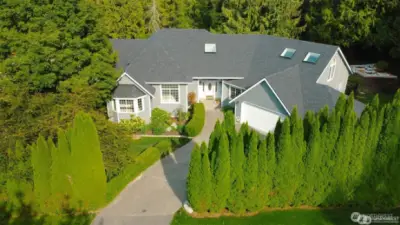 Aerial view showcasing the picturesque estate - featuring the new roof, new exterior paint, beautiful lanscape and private setting.