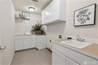 Main floor utility room. New flooring installed. Professionally Staged.