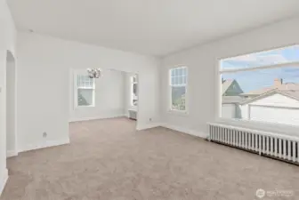 Upper-level living room looking into the formal dining area.