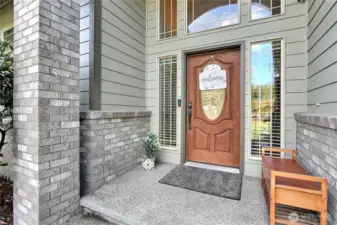 Step up to the home’s stunning, covered front porch where timeless charm. The tall, arched entryway makes a bold statement, welcoming guests with elegance and warmth. Framed in beautiful stonework and accented by rich wood tones, this inviting space sets the tone for what lies beyond. It’s the perfect first impression!