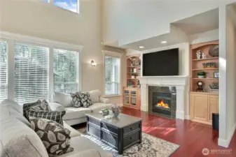 The gathering room is designed for both comfort and style, featuring custom built-ins that elegantly frame the cozy gas fireplace—perfect for showcasing your favorite books, décor, or media. Above, a drop-down theatre ceiling adds a touch of drama and enhances acoustics, creating an immersive atmosphere ideal for movie nights.