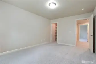 Bedroom one is spacious and bright, featuring plush carpeting that adds warmth and comfort underfoot. This inviting room also boasts a large walk-in closet, providing plenty of  storage.