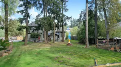 The backyard is a private, where mature trees provide plenty of natural shade, creating a cool and inviting atmosphere. This peaceful setting is perfect for your chicken coop, offering a comfortable home for your feathered friends. Nearby, a large garden thrives under the dappled sunlight, ready for growing fresh veggies, flowers, or whatever your green thumb desires.