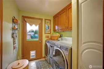 Utility room with heated tile floor..
