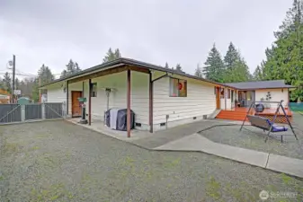 Plenty of room for an RV, plus a nice covered protected area off of garage..