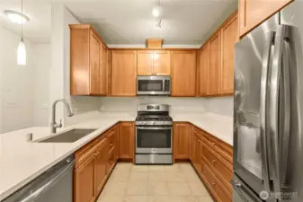 Kitchen has granite countertops, gas oven with cooktop and stainless steel appliances