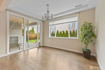 Large breakfast nook with slider to covered patio with fire place
