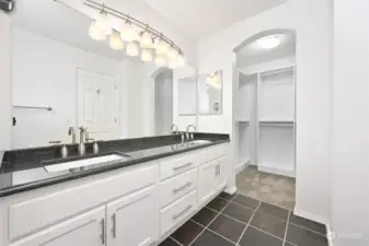 Large master bath with double sinks and a walk-in closet.