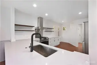 Ample counter space and a deep stainless sink provide great working space.