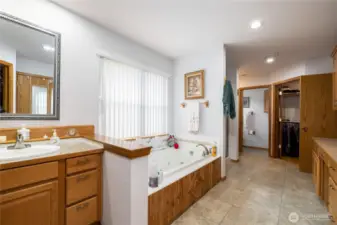 Primary bathroom has double separate sinks, double separate toilets, a jetted tub plus a shower and a built in counter.