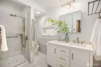The primary bathroom offers heated floors, porcelain tile, and dual undermount sinks. Timeless, elegant finishes are a welcome reprieve from trendy renovations.