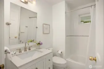 Adjacent to the front hall and just steps from the home’s entertaining spaces, your guests will appreciate this full bathroom.