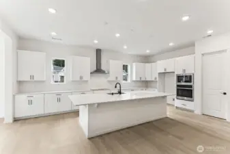 ***Actual Home *** Large kitchen and island with fabulous cabinets, walk in pantry and tons of light