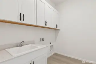 ***Actual Home *** Laundry with large deep sink, lots of cabinets for storage